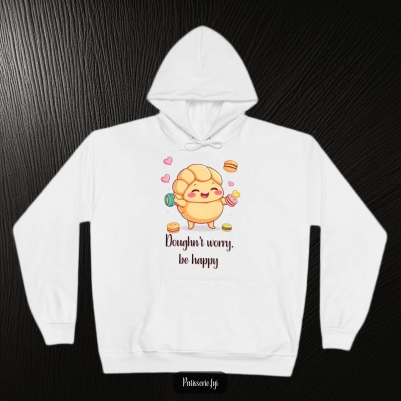 Funny Croissant Hoodie featuring a plump croissant character giggling and juggling macarons, ideal for cozy and humorous wear.