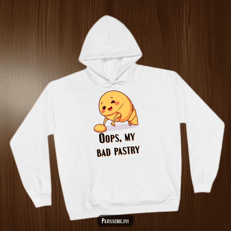 Funny Croissant Hoodie with a smiling croissant character tripping over its pastry feet, offering comfort and a dash of baked goods humor.